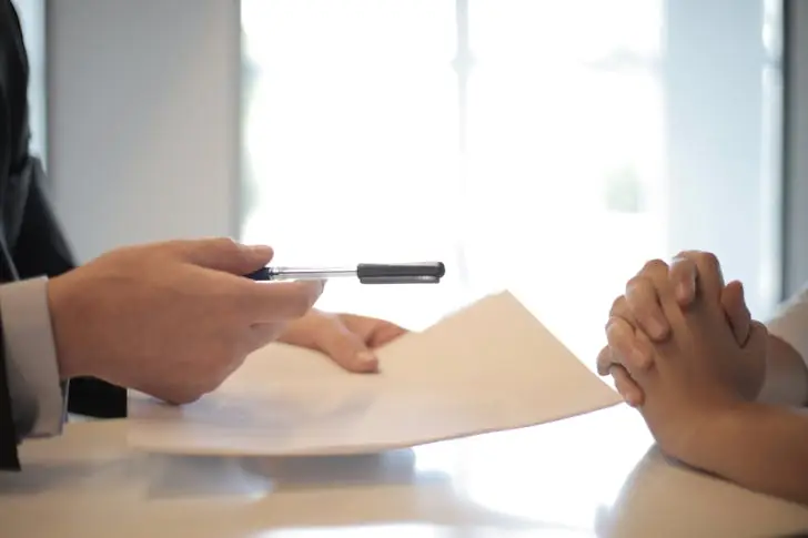 Southwest cancellation policy - A person receiving a paper to sign.